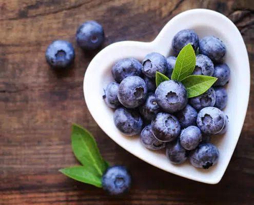 heart shaped bowl of blueberries