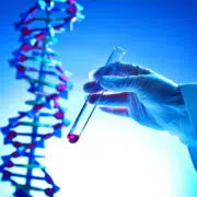 hand holding a vial with a depiction of DNA in the background